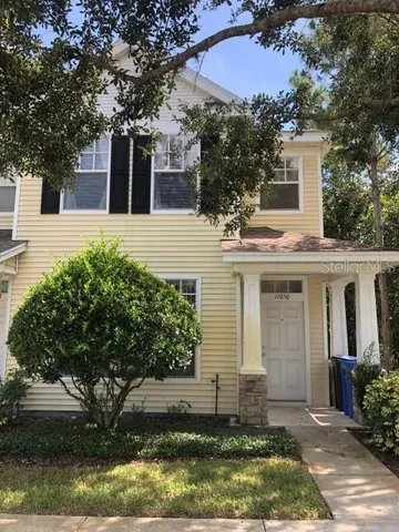 a front view of a house with a yard garage and outdoor seating