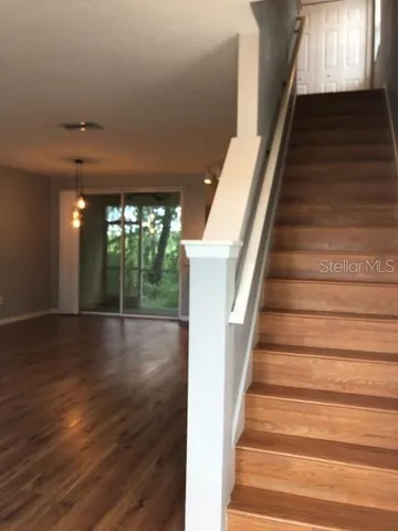 a view of entryway and hall with wooden floor