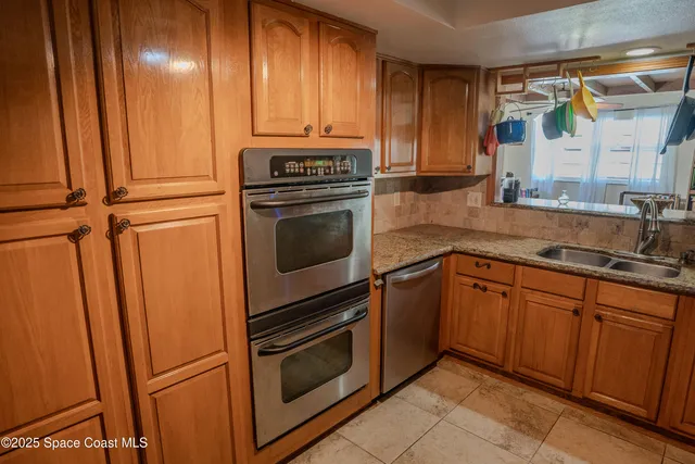 a kitchen with stainless steel appliances granite countertop cabinets and refrigerator