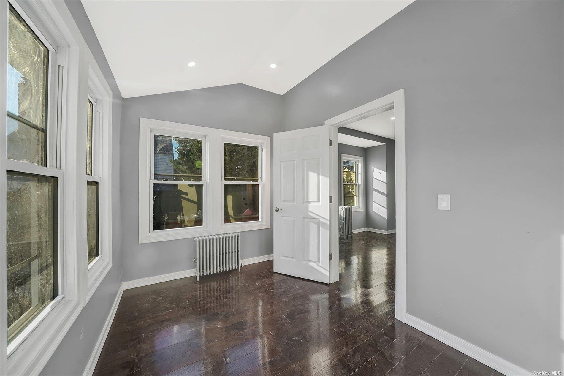 247-14 137th Road Queens, NY 11422 - Photo 12 of 34 a view of empty room with wooden floor and fan