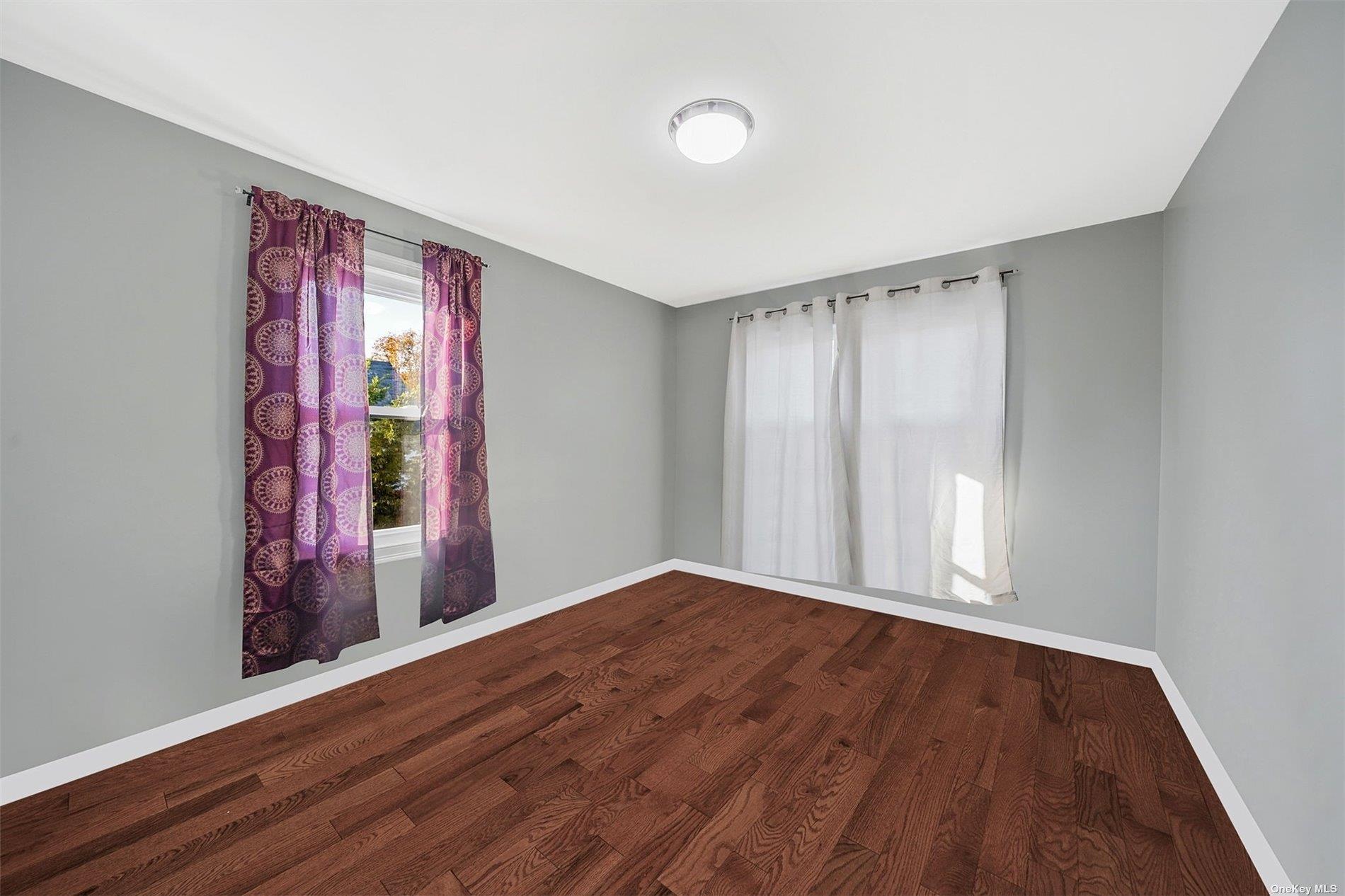 247-14 137th Road Queens, NY 11422 - Photo 16 of 34 wooden floor in an empty room with a window