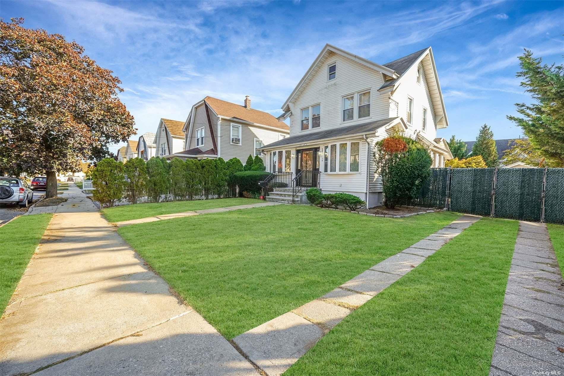 247-14 137th Road Queens, NY 11422 - Photo 2 of 34 a front view of house with yard and green space