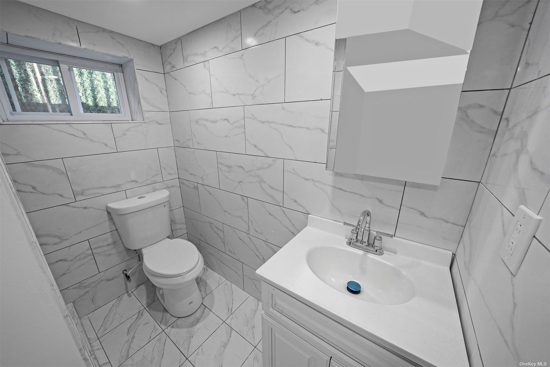 247-14 137th Road Queens, NY 11422 - Photo 23 of 34 a bathroom with a sink toilet and a mirror