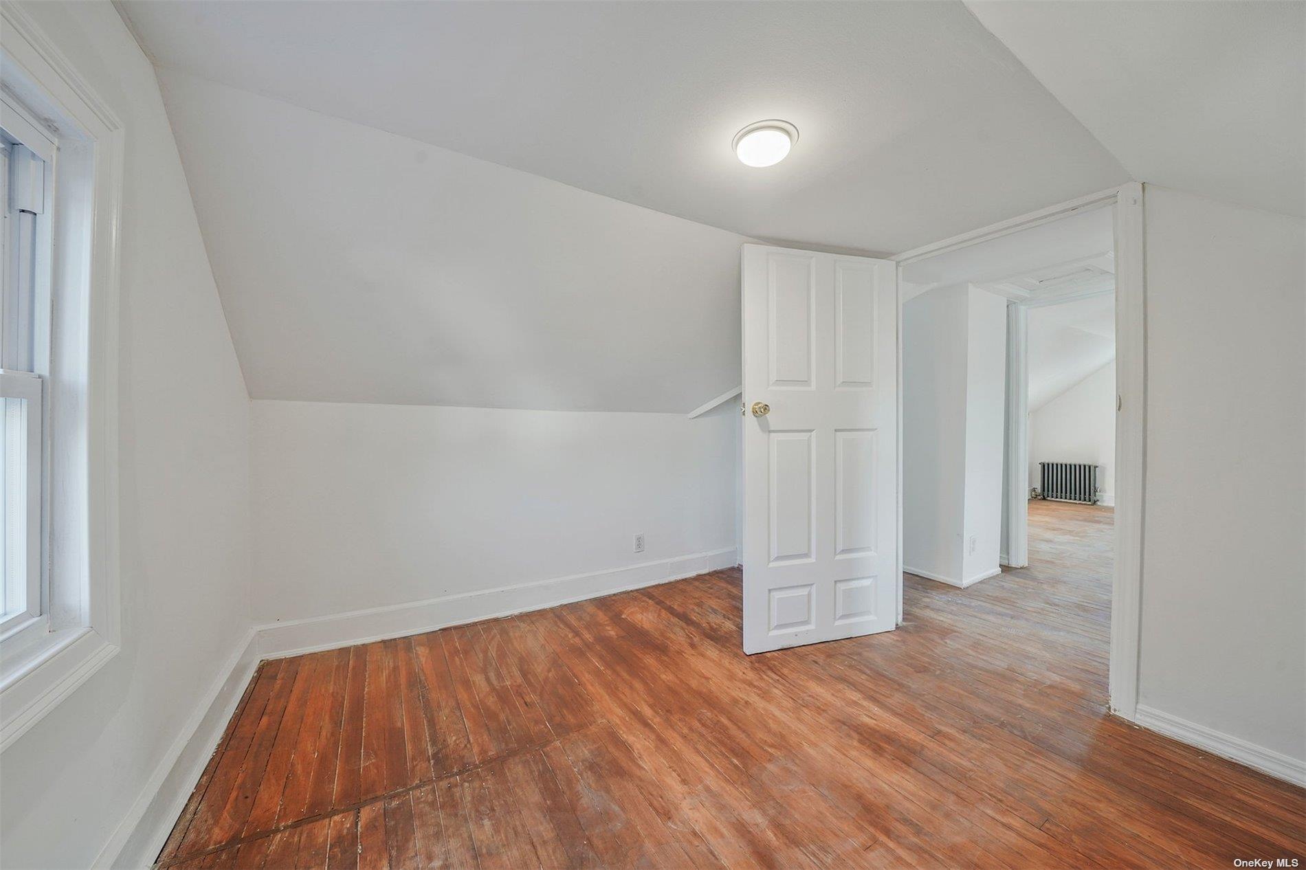 247-14 137th Road Queens, NY 11422 - Photo 26 of 34 wooden floor in an empty room