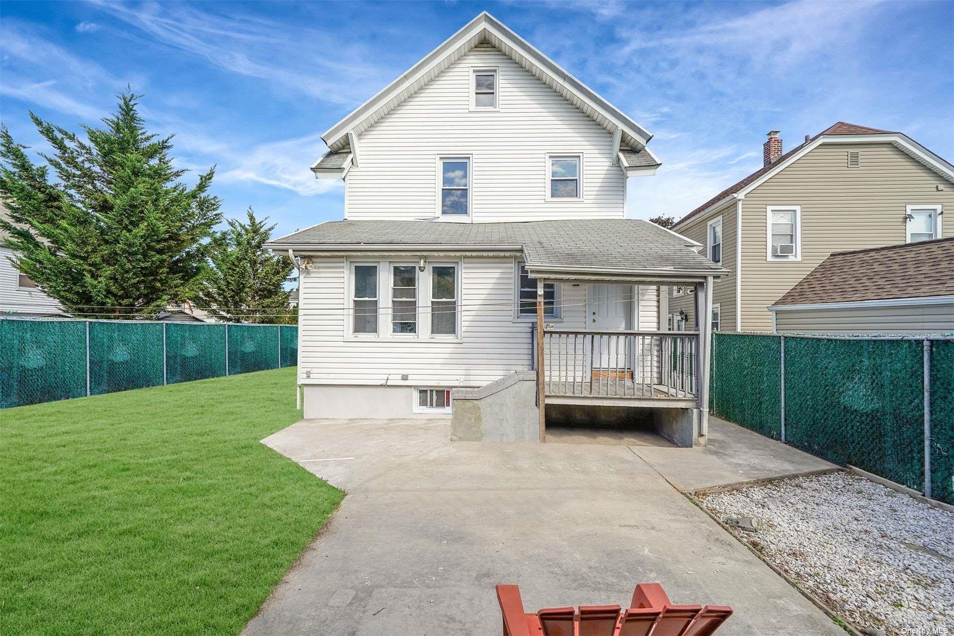 247-14 137th Road Queens, NY 11422 - Photo 32 of 34 a front view of a house with a yard