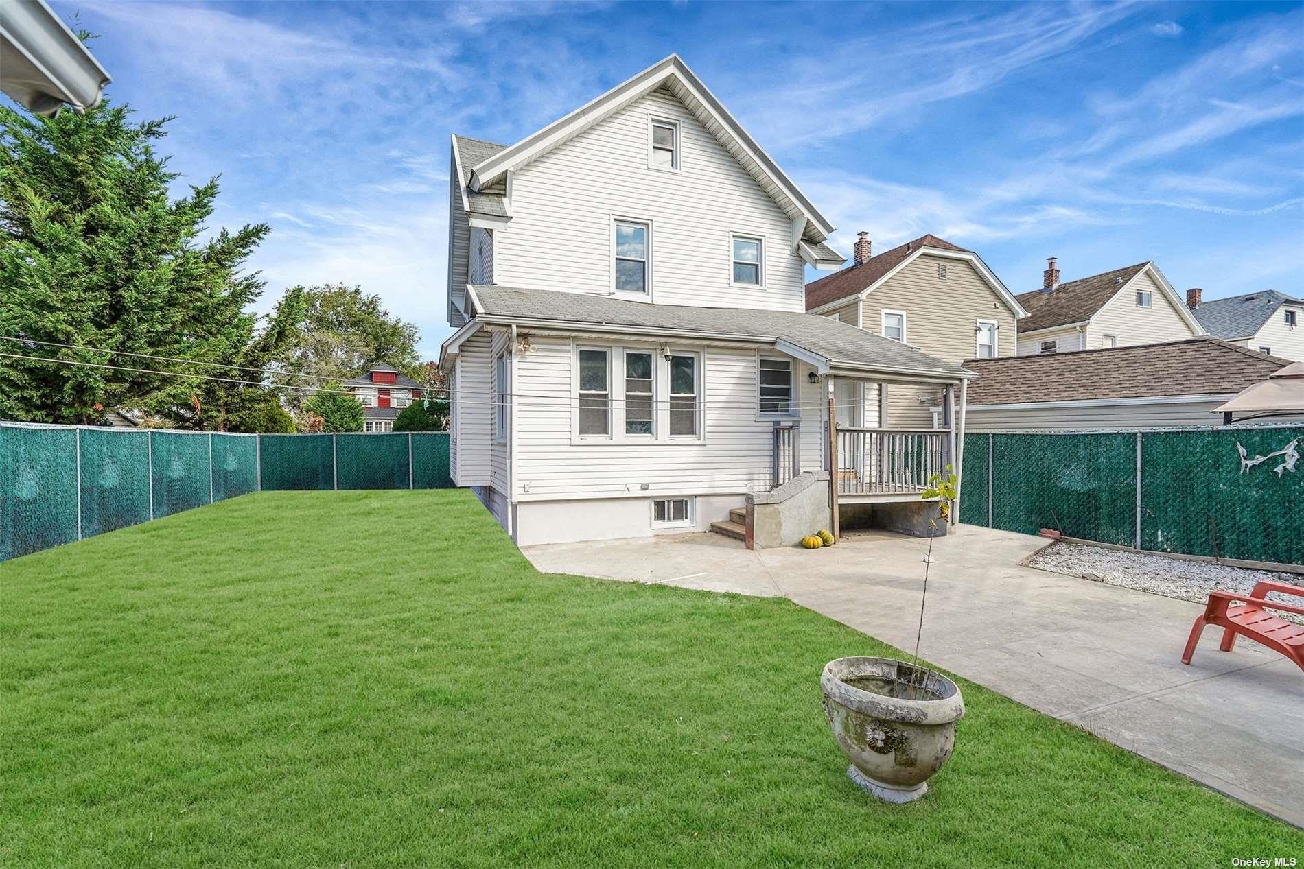 247-14 137th Road Queens, NY 11422 - Photo 33 of 34 a front view of a house with a yard