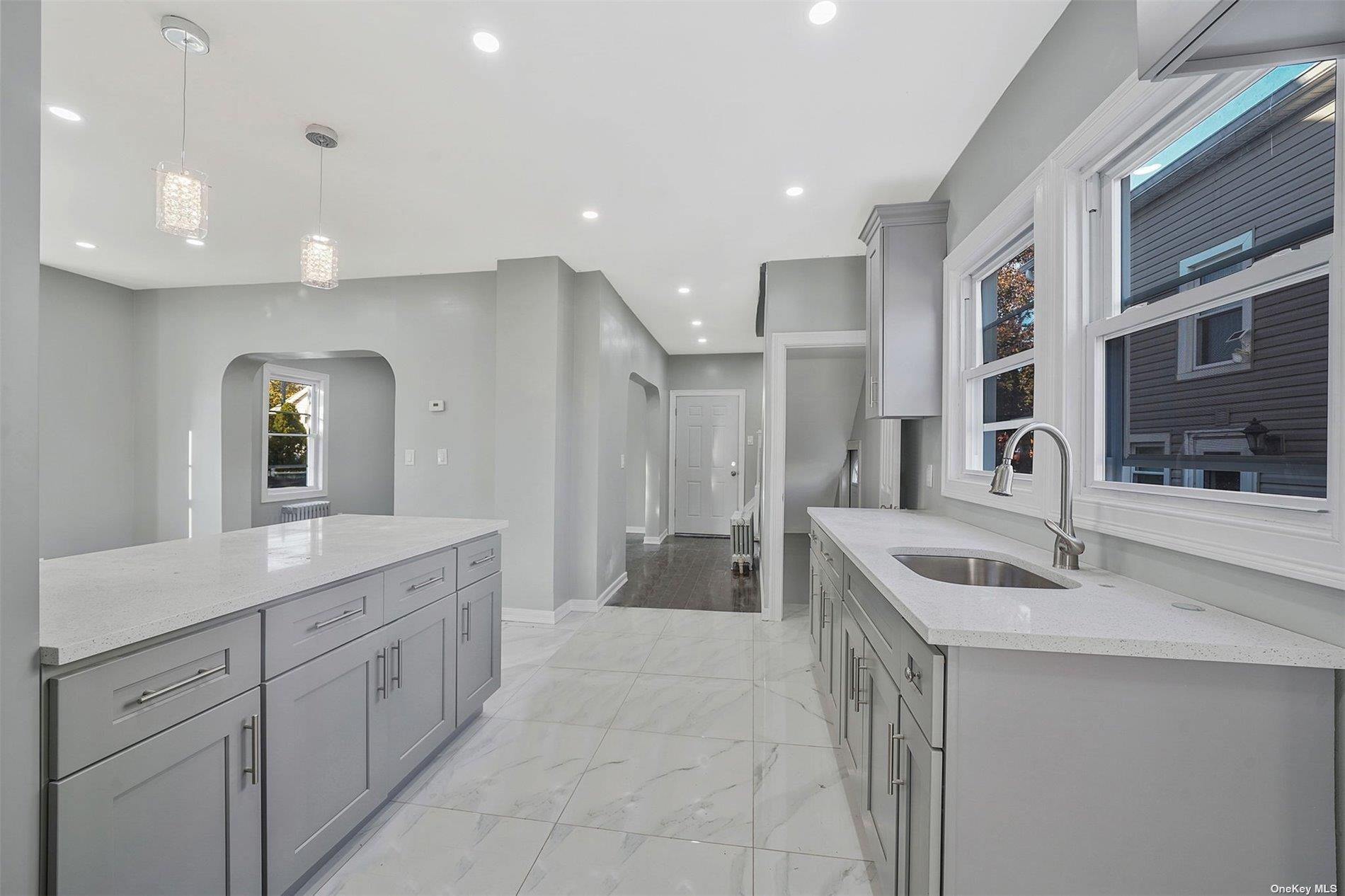 247-14 137th Road Queens, NY 11422 - Photo 6 of 34 a spacious bathroom with a sink and a mirror
