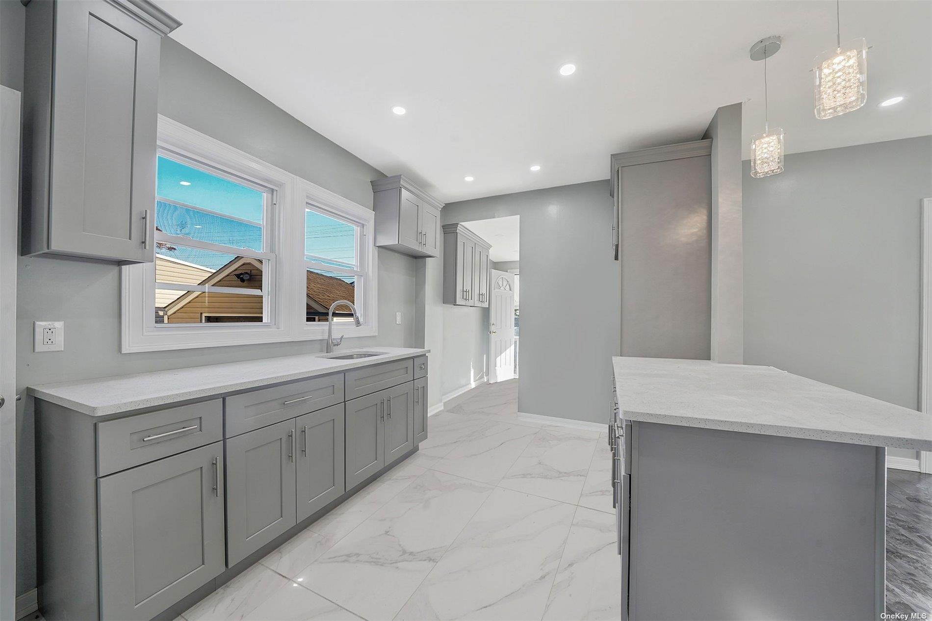 247-14 137th Road Queens, NY 11422 - Photo 8 of 34 a large bathroom with a sink and a mirror