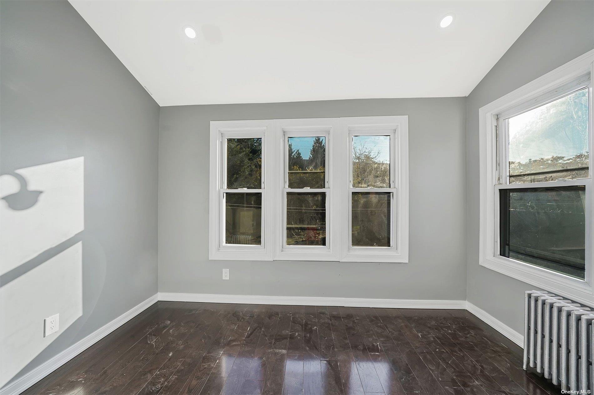 247-14 137th Road Queens, NY 11422 - Photo 9 of 34 a view of an empty room with wooden floor and a window