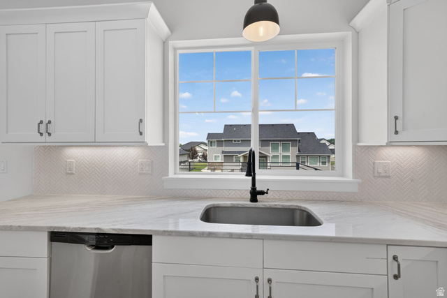 1002 West Temple Rim Lane Payson, UT 84651 - Photo 19 of 68 Kitchen features a stainless steel undermount sink with a matte black faucet, set within a light-toned countertop