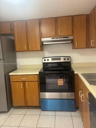 a stove top oven sitting inside of a kitchen
