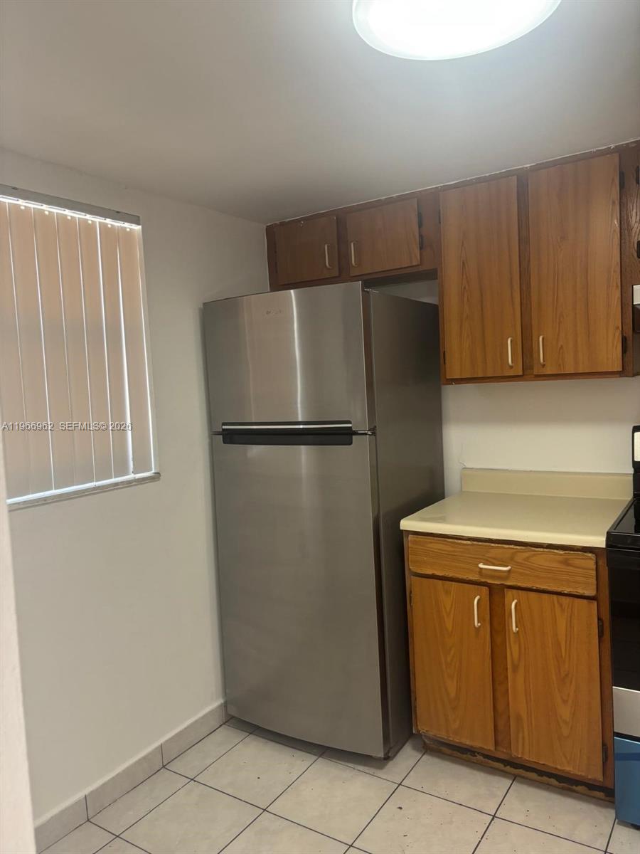 19715 Southwest 114th Avenue, Unit 352 Miami, FL 33157 - Photo 4 of 10 a kitchen with a refrigerator and a stove