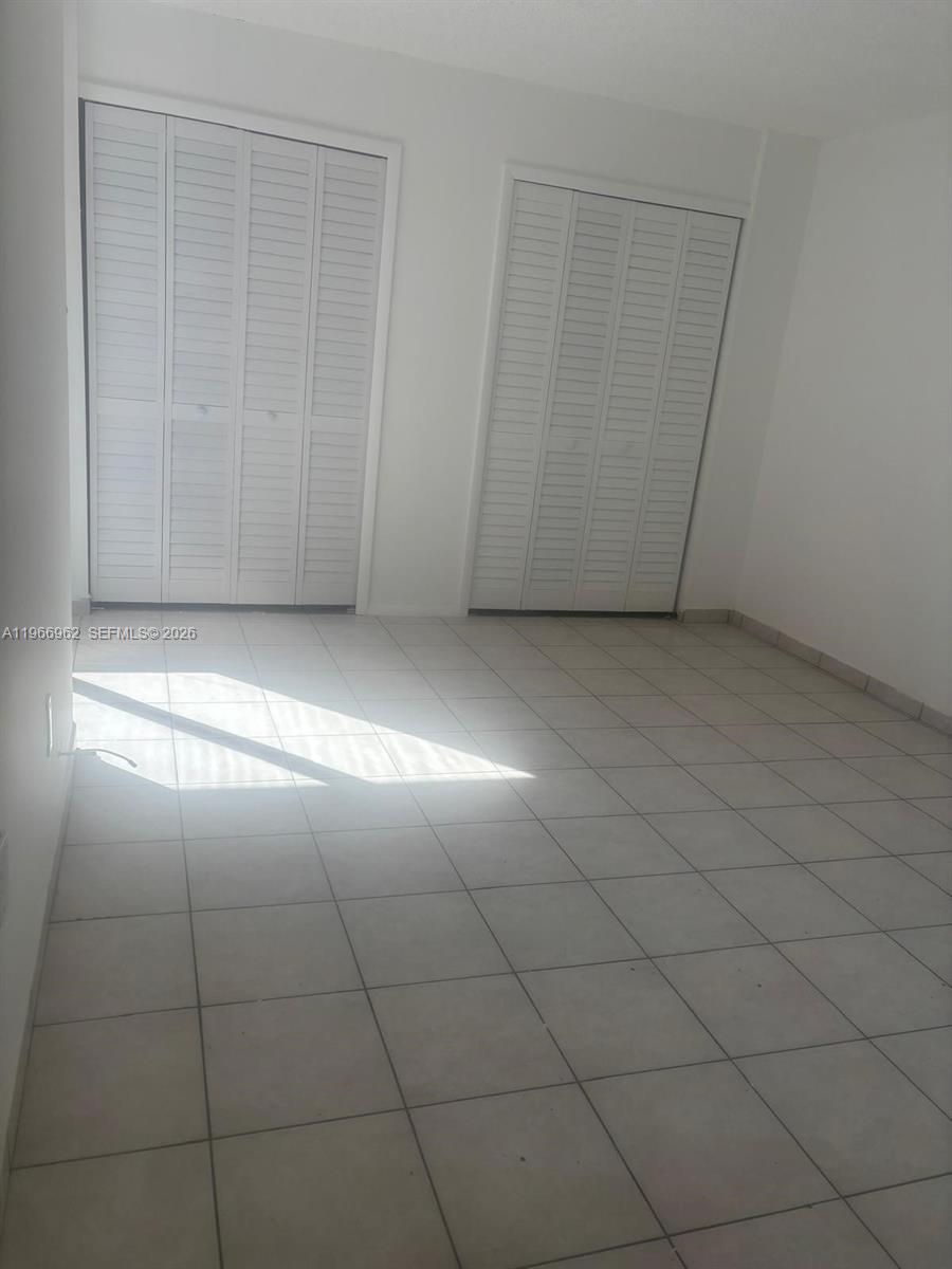 19715 Southwest 114th Avenue, Unit 352 Miami, FL 33157 - Photo 5 of 10 wooden floor in a empty room