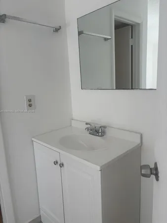 a bathroom with a sink and mirror
