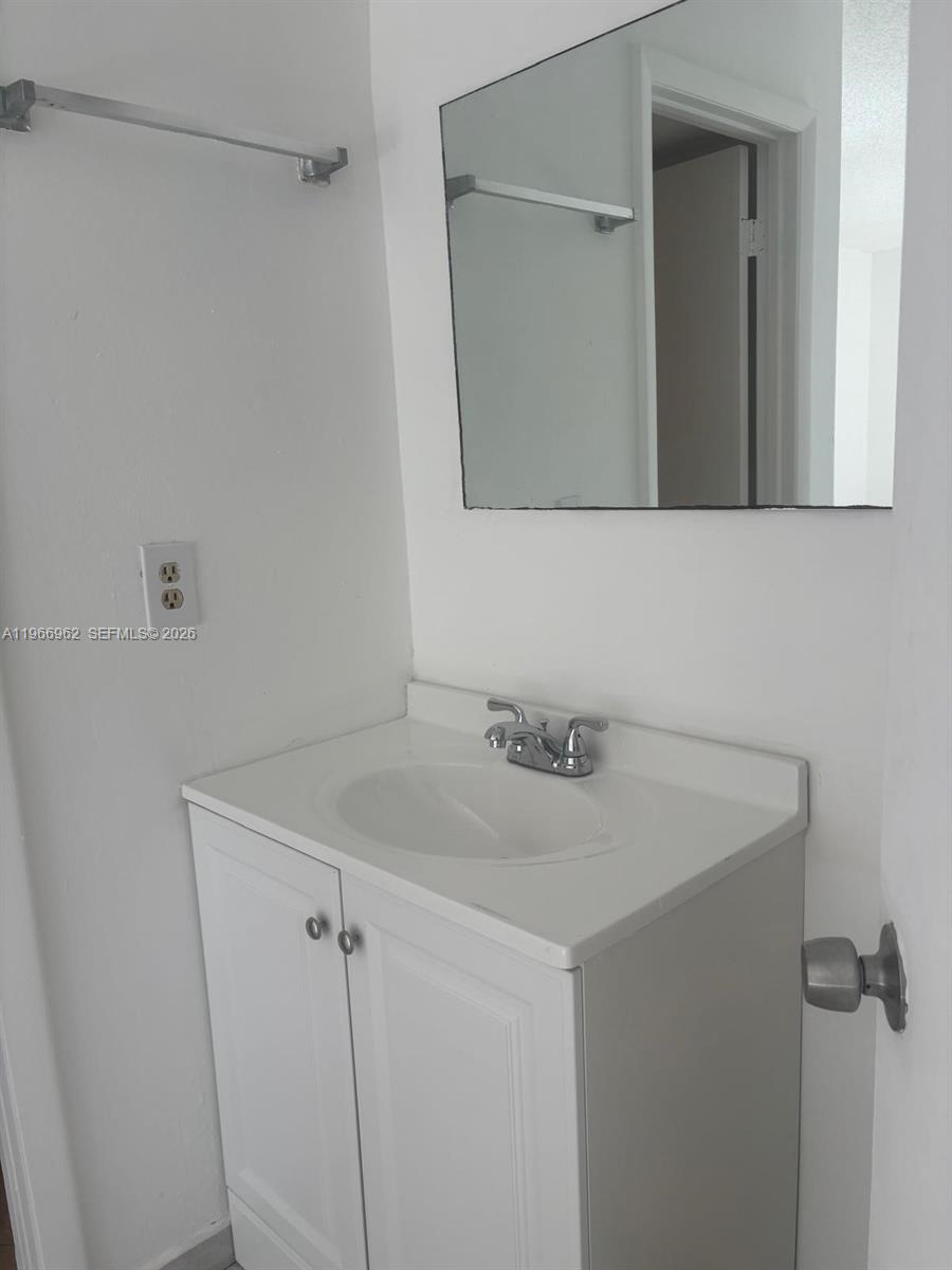 19715 Southwest 114th Avenue, Unit 352 Miami, FL 33157 - Photo 6 of 10 a bathroom with a sink and mirror