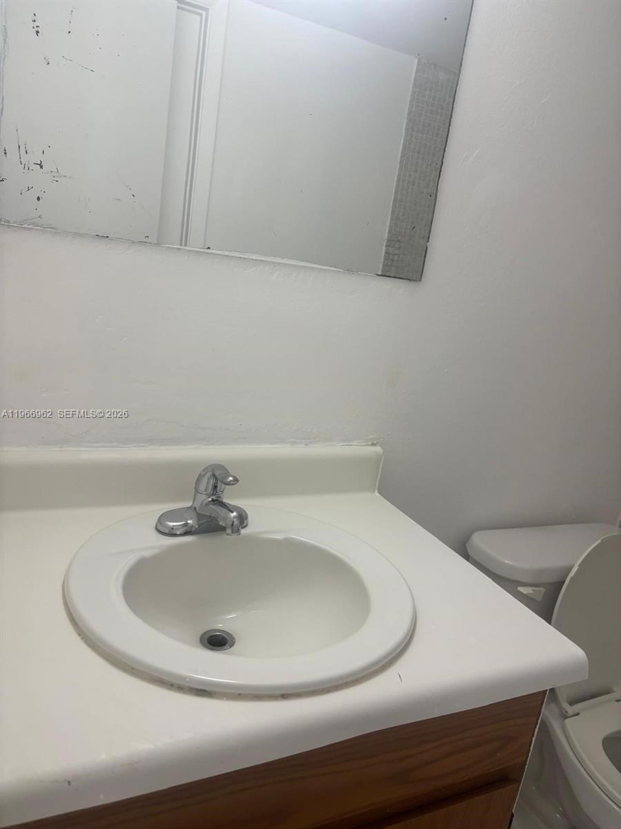 19715 Southwest 114th Avenue, Unit 352 Miami, FL 33157 - Photo 8 of 10 a bathroom with a sink and a toilet
