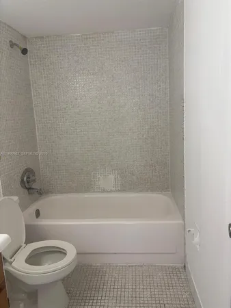 a bathroom with a toilet and a bathtub