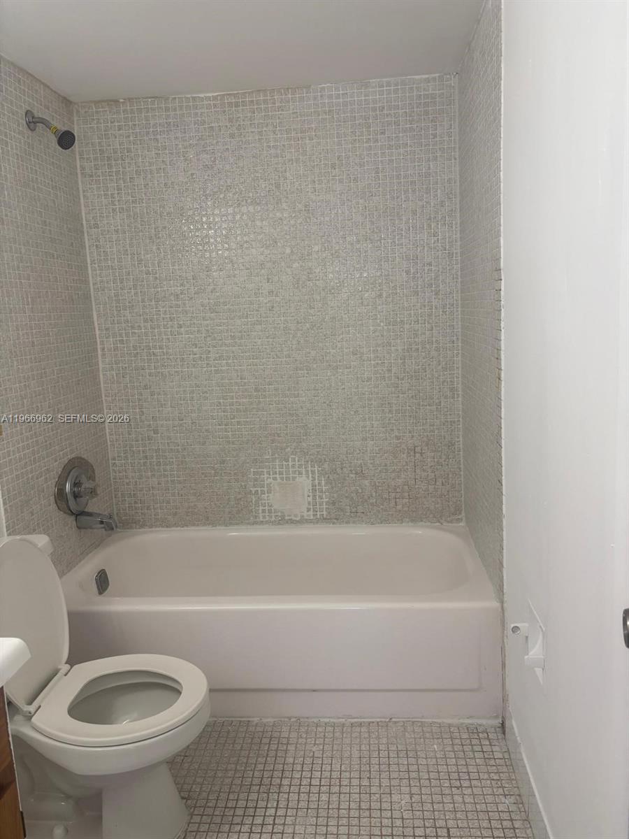 19715 Southwest 114th Avenue, Unit 352 Miami, FL 33157 - Photo 9 of 10 a bathroom with a toilet and a bathtub