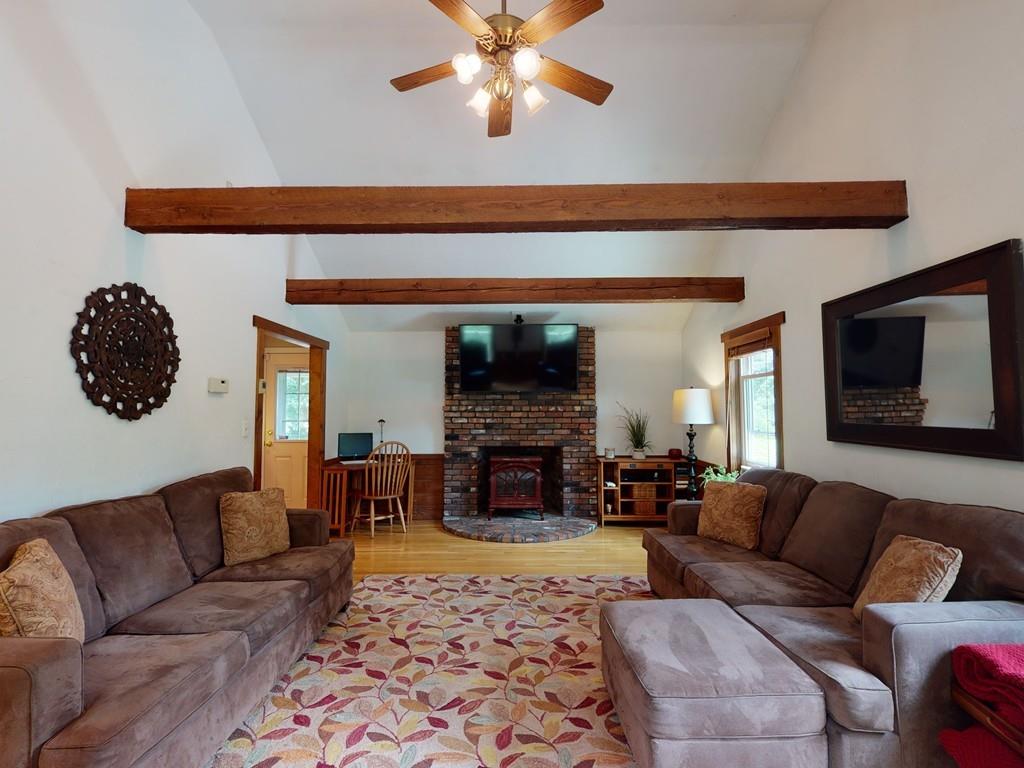 17 Nyra Road Stow, MA 01775 - Photo 11 of 26 a living room with furniture a fireplace and a chandelier