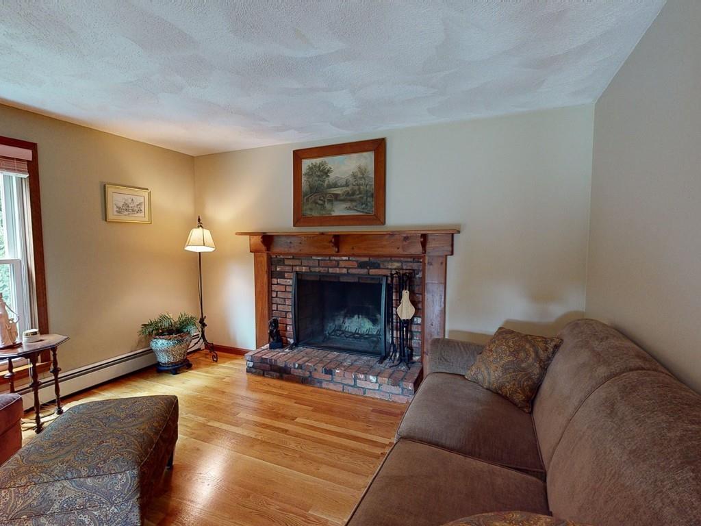 17 Nyra Road Stow, MA 01775 - Photo 17 of 26 a living room with furniture and a fireplace