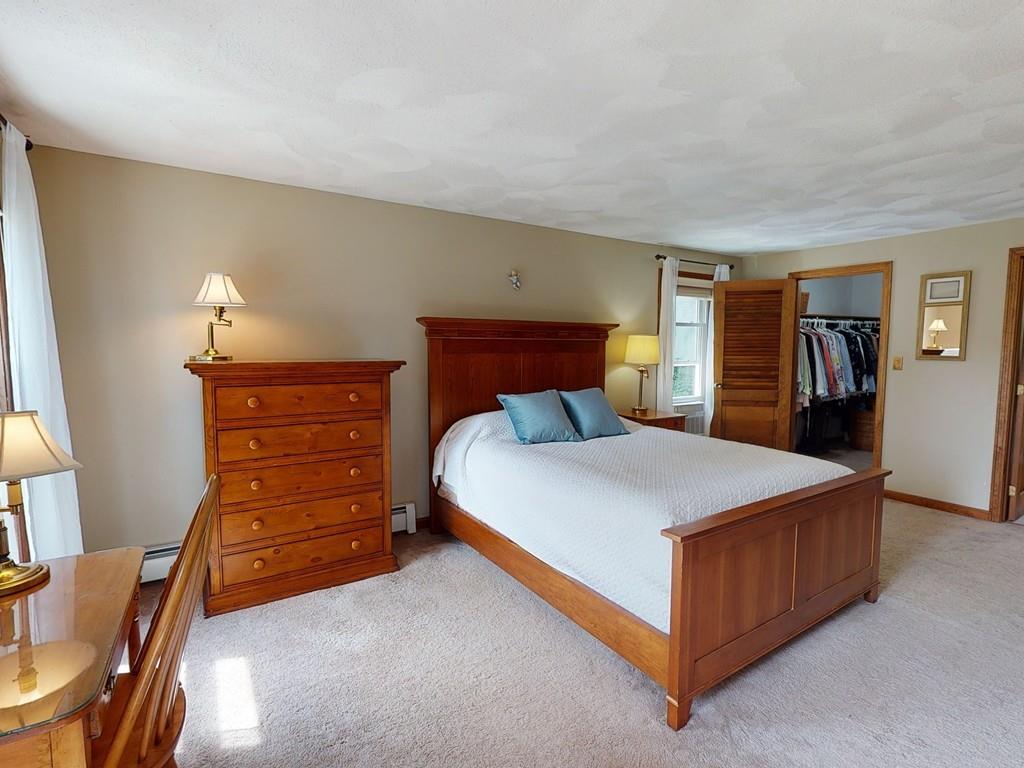 17 Nyra Road Stow, MA 01775 - Photo 18 of 26 a bedroom with a bed and a dresser in it
