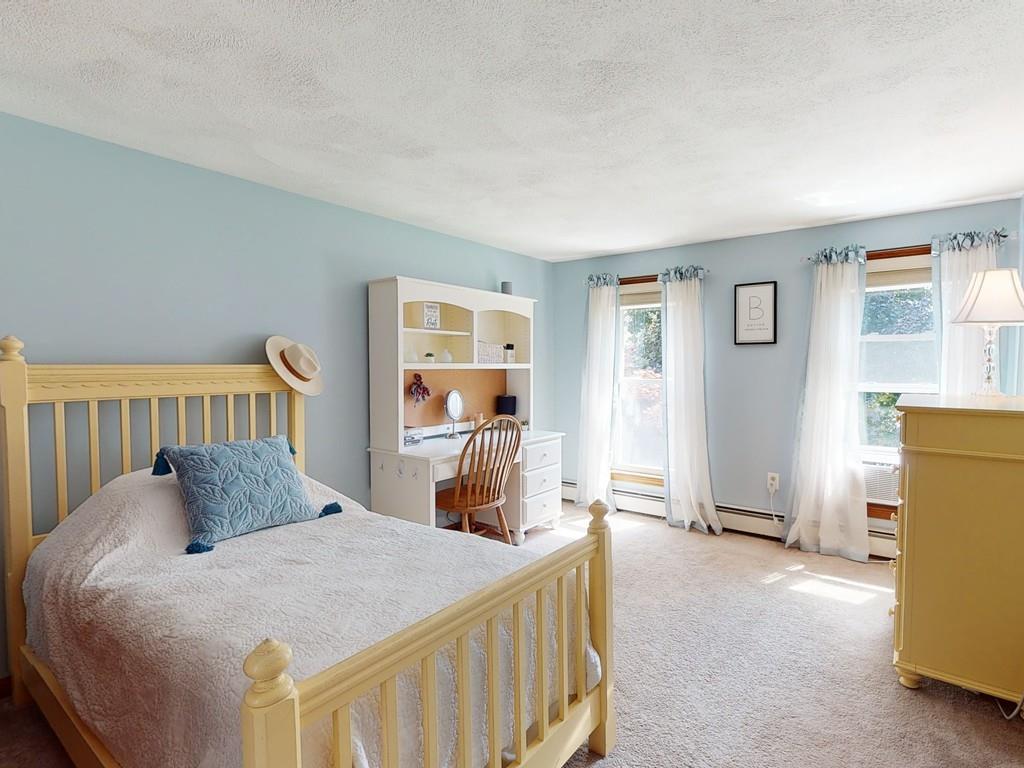 17 Nyra Road Stow, MA 01775 - Photo 20 of 26 a bedroom with a bed and wooden floor