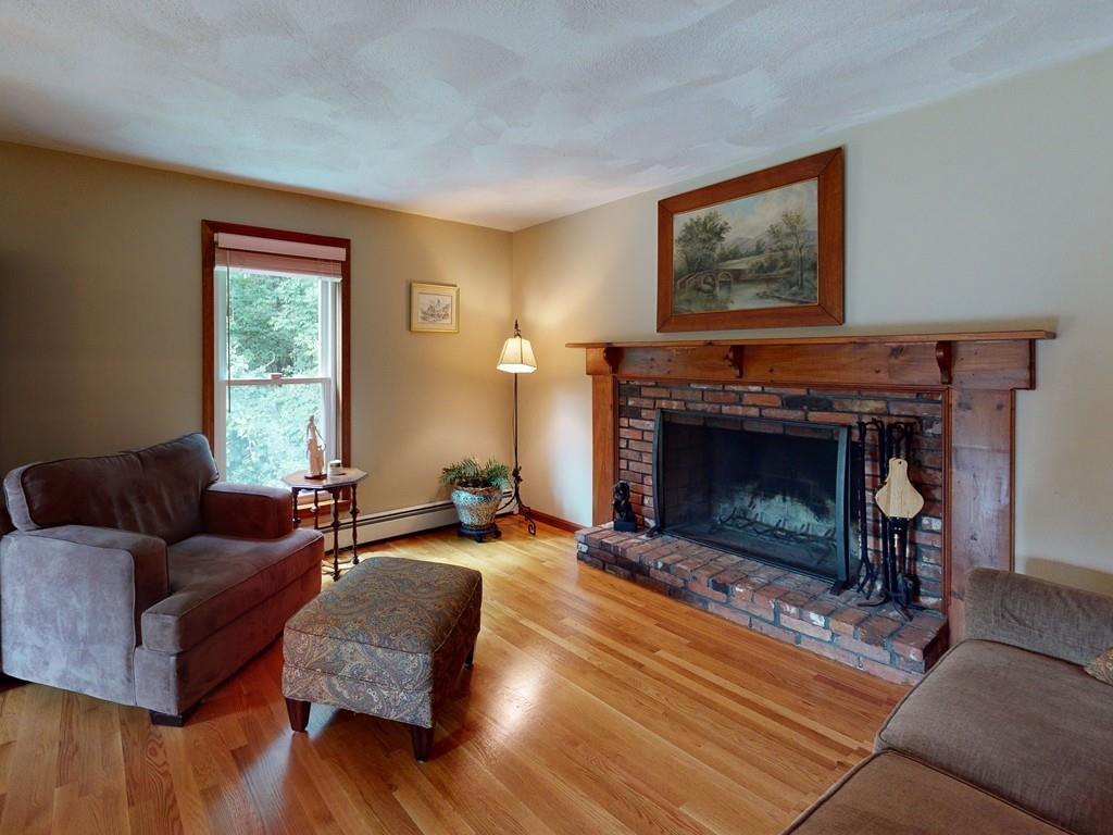 17 Nyra Road Stow, MA 01775 - Photo 22 of 26 a living room with furniture and a fireplace