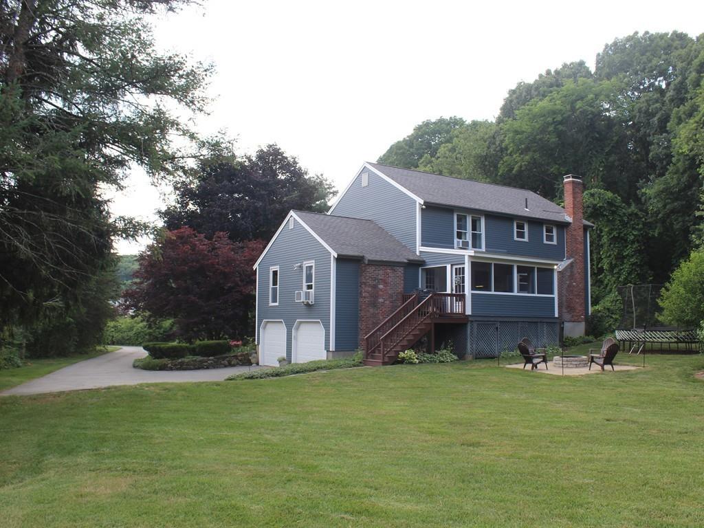 17 Nyra Road Stow, MA 01775 - Photo 24 of 26 a front view of a house with a garden and trees