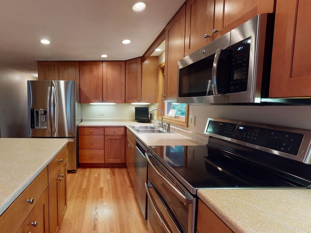 17 Nyra Road Stow, MA 01775 - Photo 9 of 26 a kitchen with stainless steel appliances granite countertop a stove a sink and a microwave