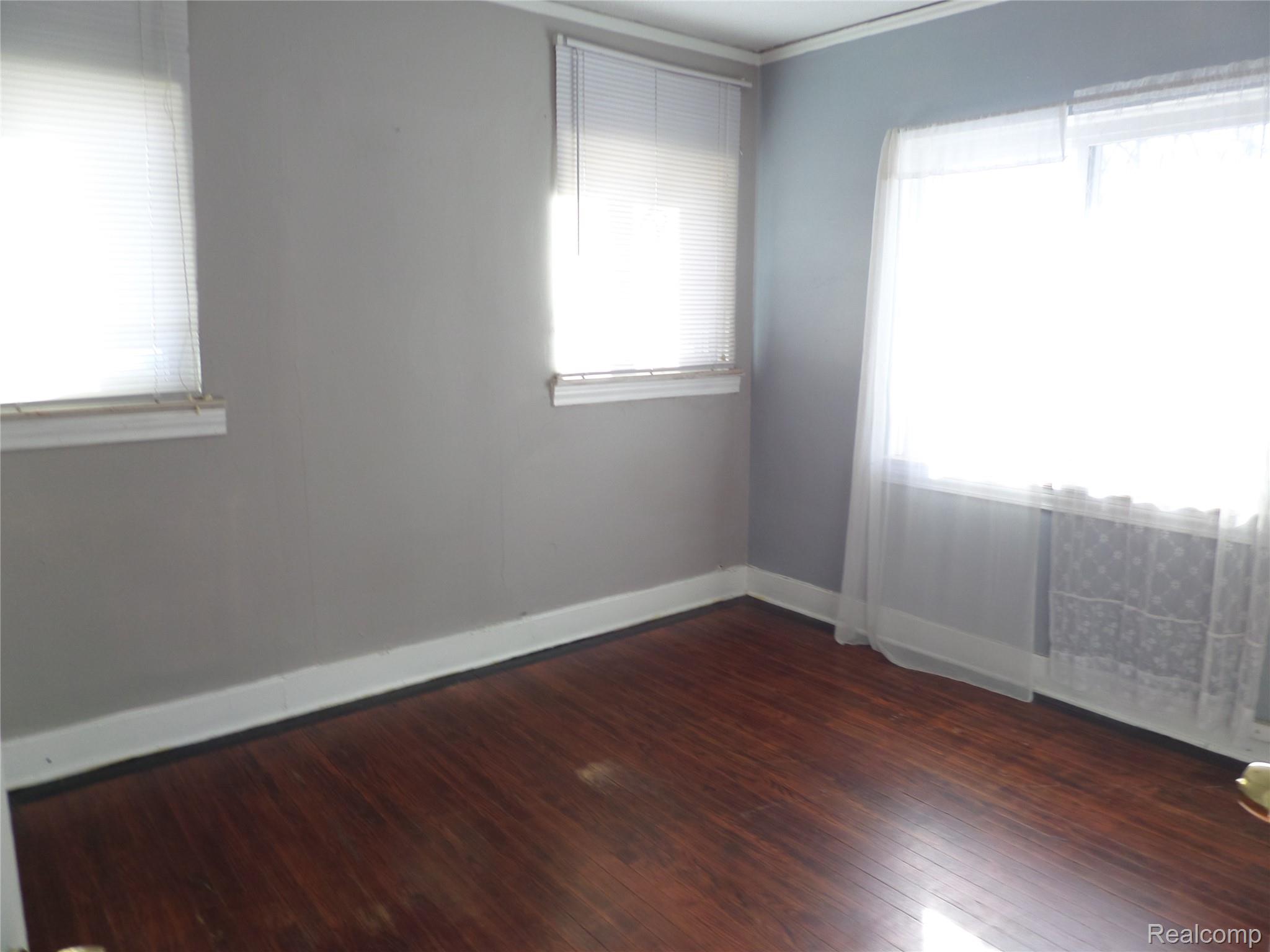 384 Perry Street Pontiac, MI 48342 - Photo 13 of 28 unit 2 Spare room with dark wood finished floors and ornamental molding