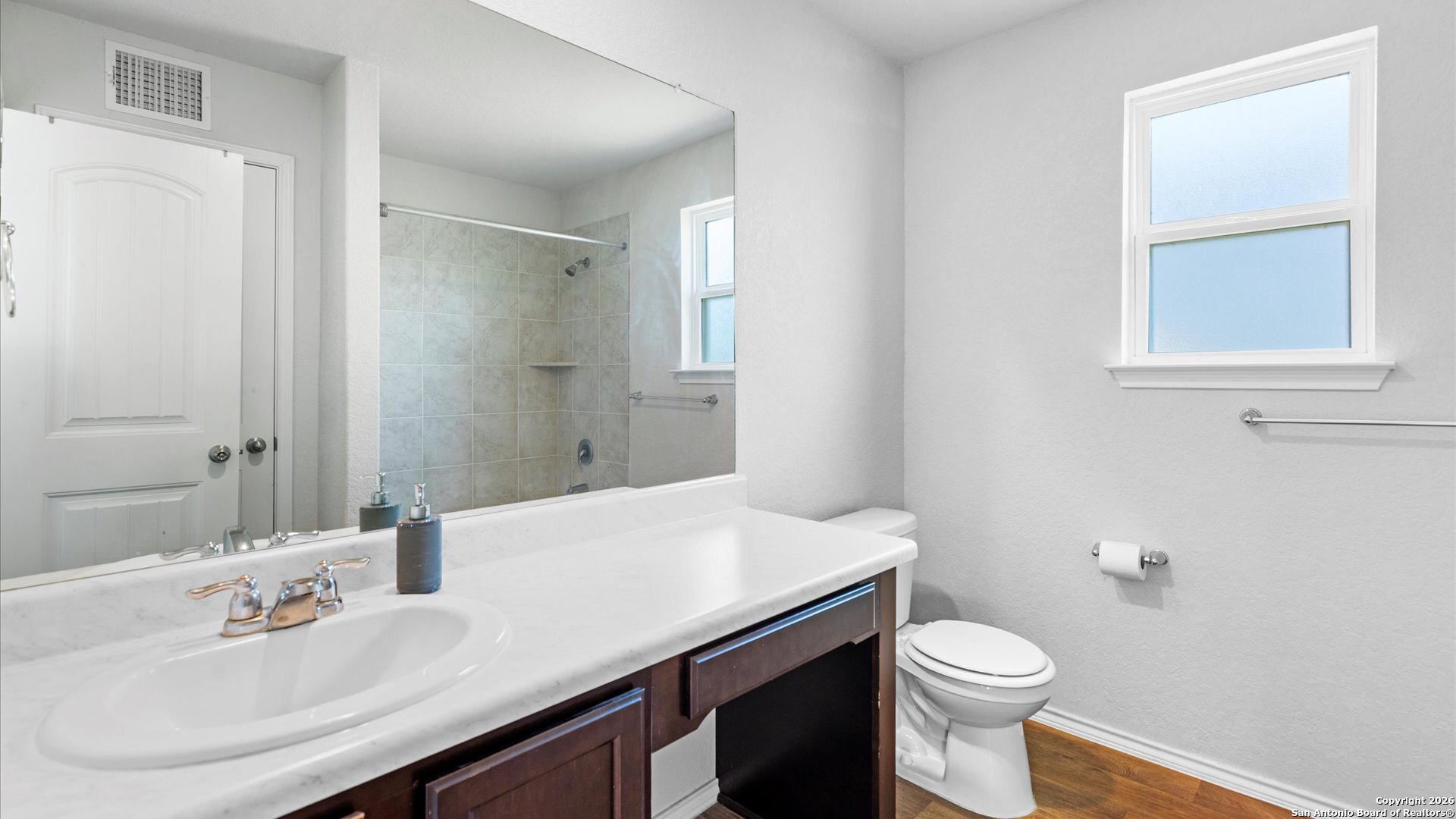7602 Powder Gorge Converse, TX 78109 - Photo 7 of 17 a bathroom with a sink a toilet and a mirror