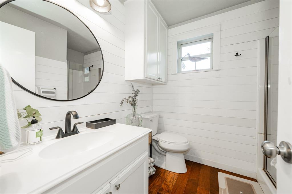 970 North Country Lane Rockwall, TX 75087 - Photo 18 of 40 a bathroom with a sink a toilet and a mirror