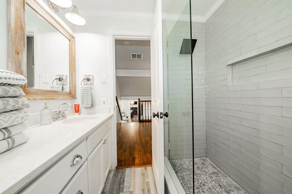 970 North Country Lane Rockwall, TX 75087 - Photo 21 of 40 a bathroom with a sink and a mirror