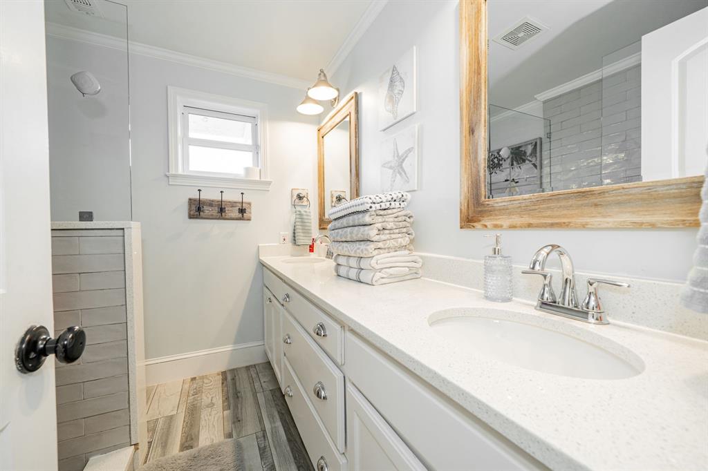 970 North Country Lane Rockwall, TX 75087 - Photo 22 of 40 a bathroom with a double vanity sink and mirror