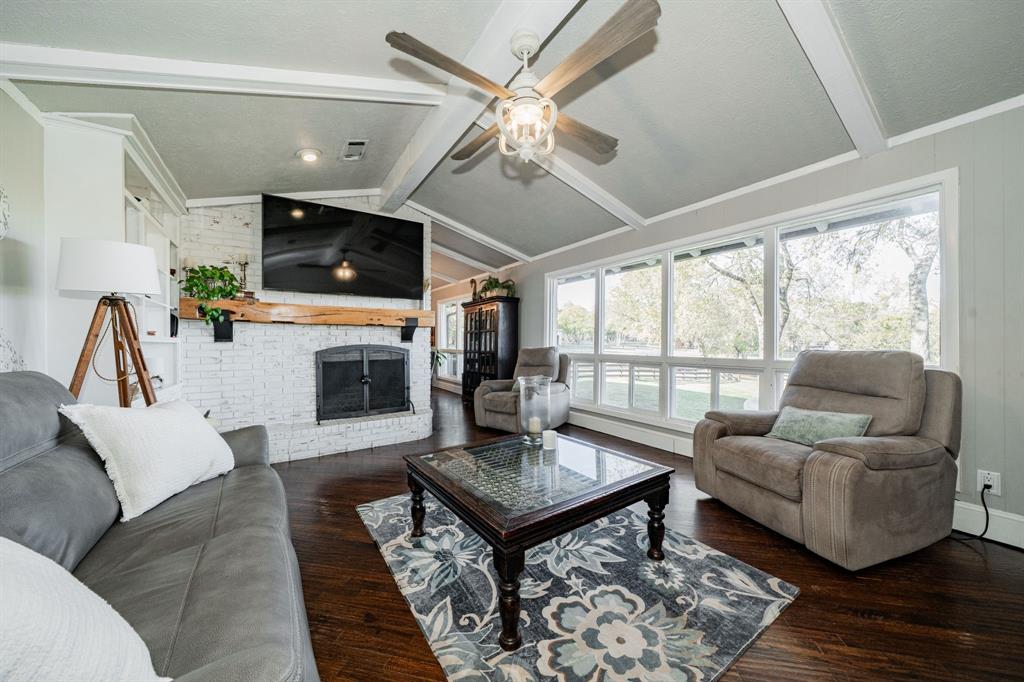970 North Country Lane Rockwall, TX 75087 - Photo 10 of 40 a living room with furniture a flat screen tv and a fireplace