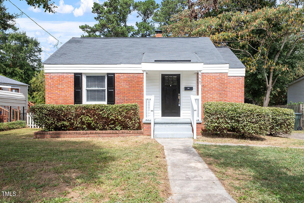 2229 Sheffield Road Raleigh, NC 27610 - Photo 1 of 30 a view of a white house next to a yard with plants and trees