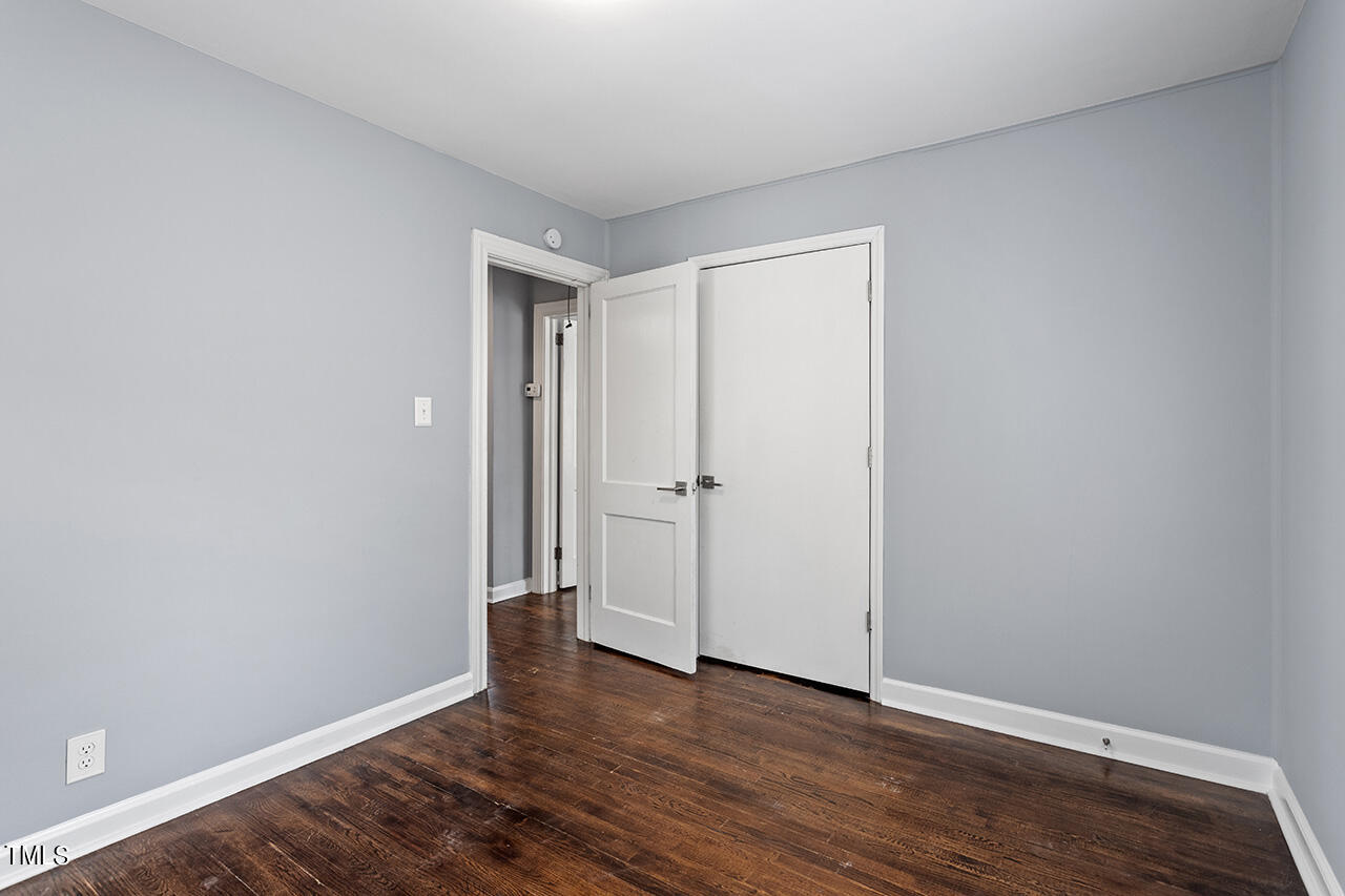 2229 Sheffield Road Raleigh, NC 27610 - Photo 16 of 30 a view of an empty room with wooden floor