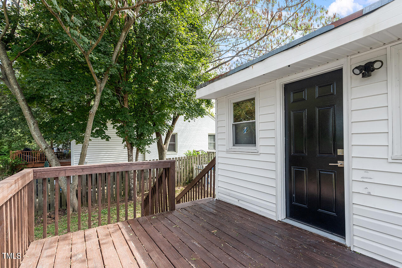 2229 Sheffield Road Raleigh, NC 27610 - Photo 26 of 30 a view of a wooden deck and a yard