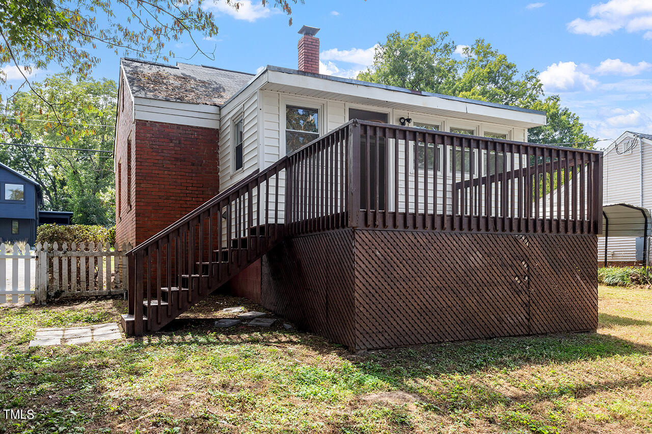 2229 Sheffield Road Raleigh, NC 27610 - Photo 28 of 30 a view of a deck with wooden fence and a floor to ceiling window
