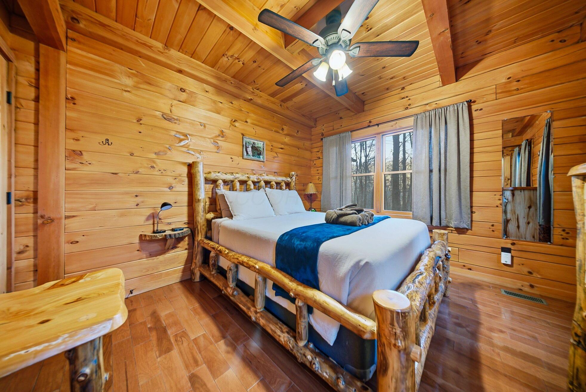 15399 Clapper Hollow Road Laurelville, OH 43135 - Photo 20 of 61 Main Level Bedroom with a Queen Bed and Custom Log Furniture