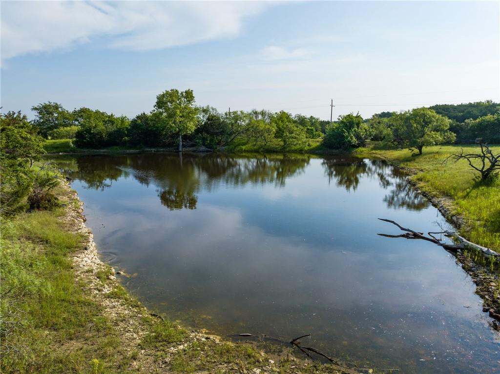 16401 Cedar Rock Parkway Crawford, TX 76638 - Photo 53 of 81 a view of a lake with houses in the back