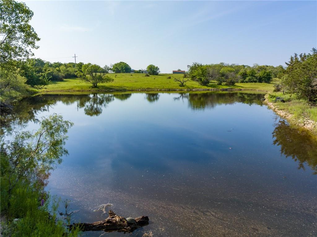 16401 Cedar Rock Parkway Crawford, TX 76638 - Photo 55 of 81 a view of a lake with houses in background