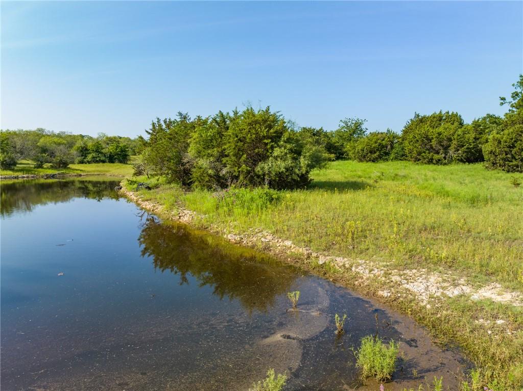 16401 Cedar Rock Parkway Crawford, TX 76638 - Photo 57 of 81 a view of a lake with houses in the background