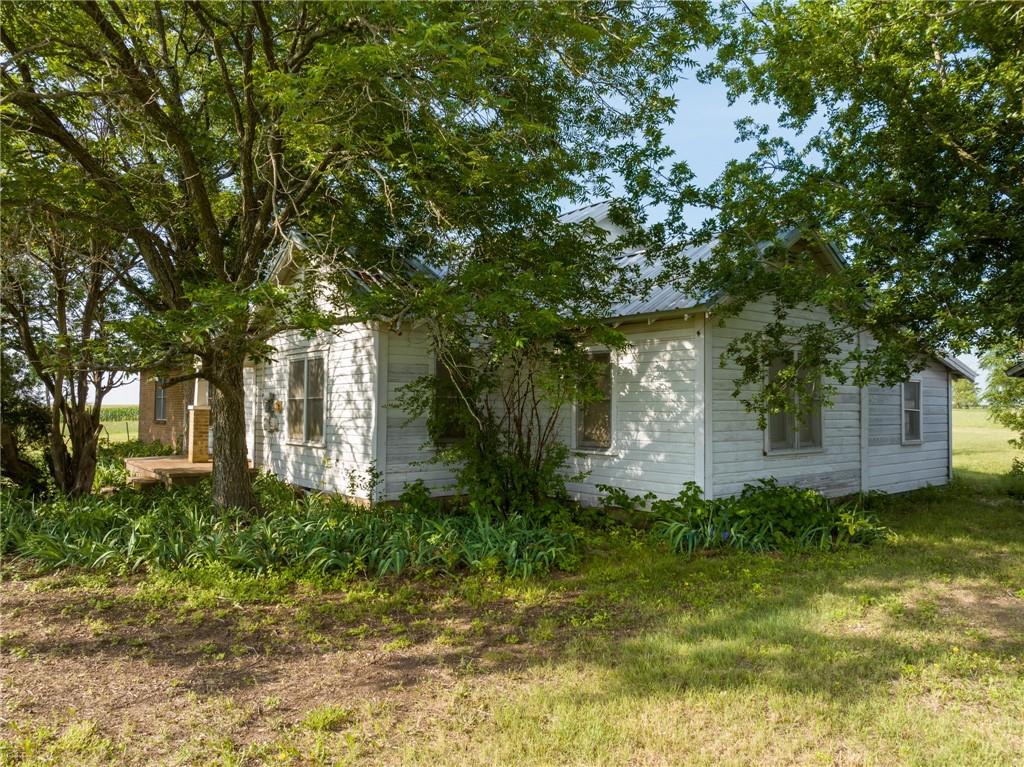 16401 Cedar Rock Parkway Crawford, TX 76638 - Photo 75 of 81 a front view of a house with garden