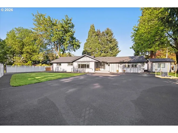 a view of a house with a yard and garage
