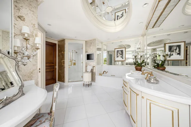 a spacious bathroom with a double vanity sink a mirror and a shower