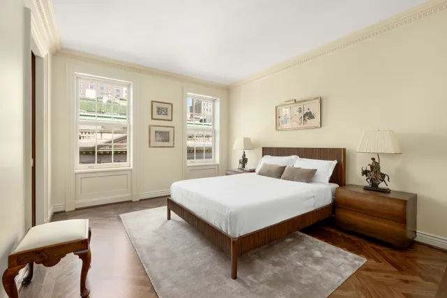 a spacious bedroom with a bed couch and a window