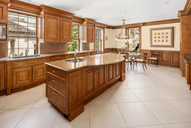 a kitchen with stainless steel appliances granite countertop a sink and a refrigerator