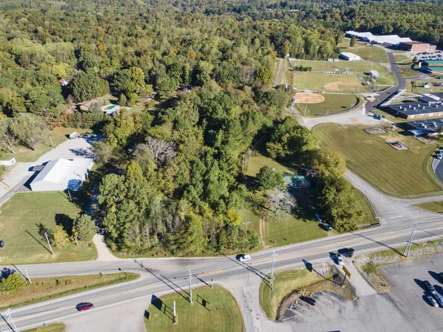 an aerial view of a house with a yard and lake view