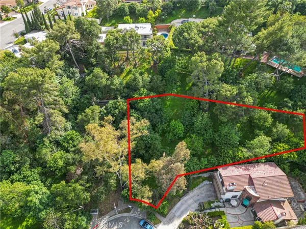 a backyard of a house with lots of green space and fountain